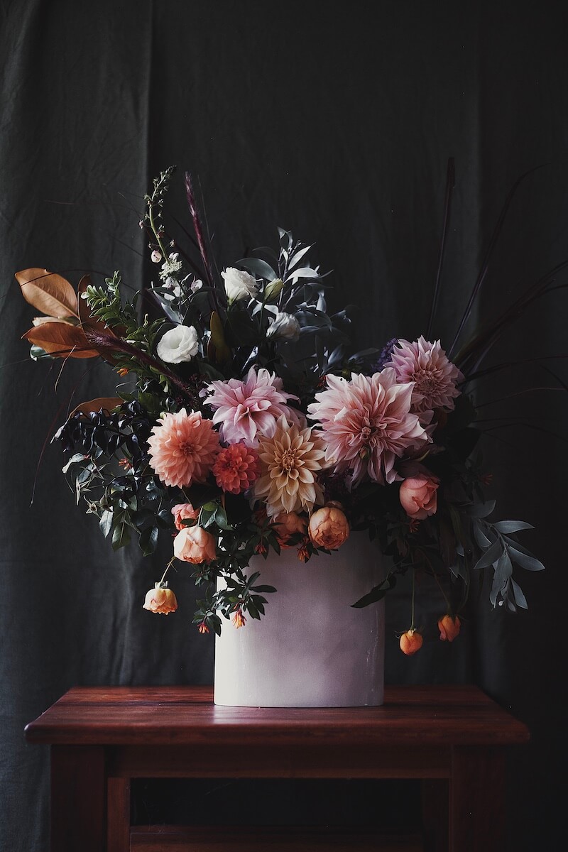 Colourful dahlia arrangement on table