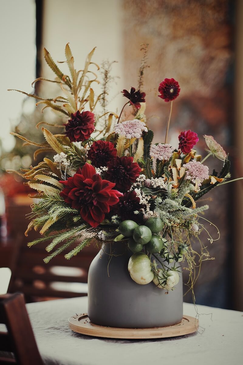 Red and green themed dahlia arragement